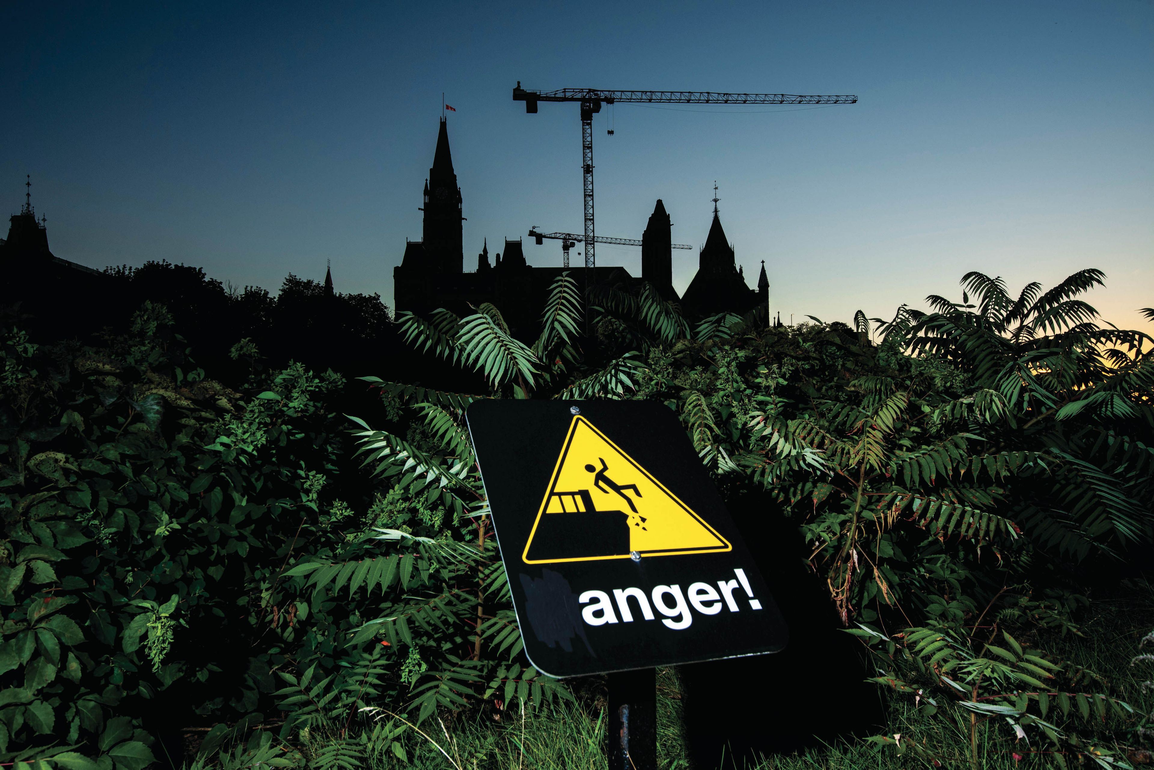 The letter "d" on a "danger" sign at Major's Hill park advising people to stay away from the cliff edge is painted over, leaving the word "anger", seen in front of Parliament Hill in Ottawa, on Thursday, Sept. 16, 2021. (Photograph by Justin Tang)