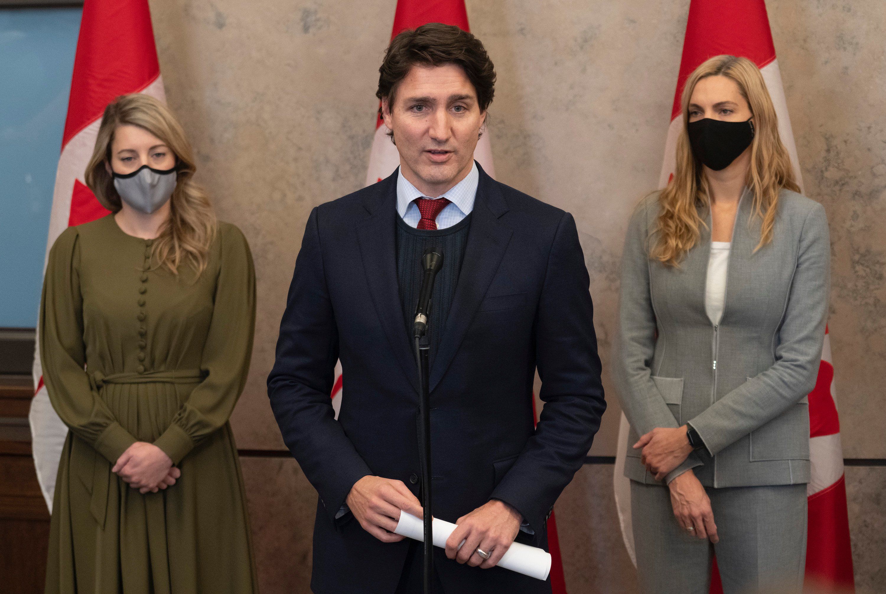 Foreign Affairs Minister Melanie Joly (left) and Sport Minister Pascale St-Onge look on as Canadian Prime Minister Justin Trudeau announces Canada will join a diplomatic boycott of the Winter Games in China following caucus, Wednesday, December 8, 2021 in Ottawa. THE CANADIAN PRESS/Adrian Wyld