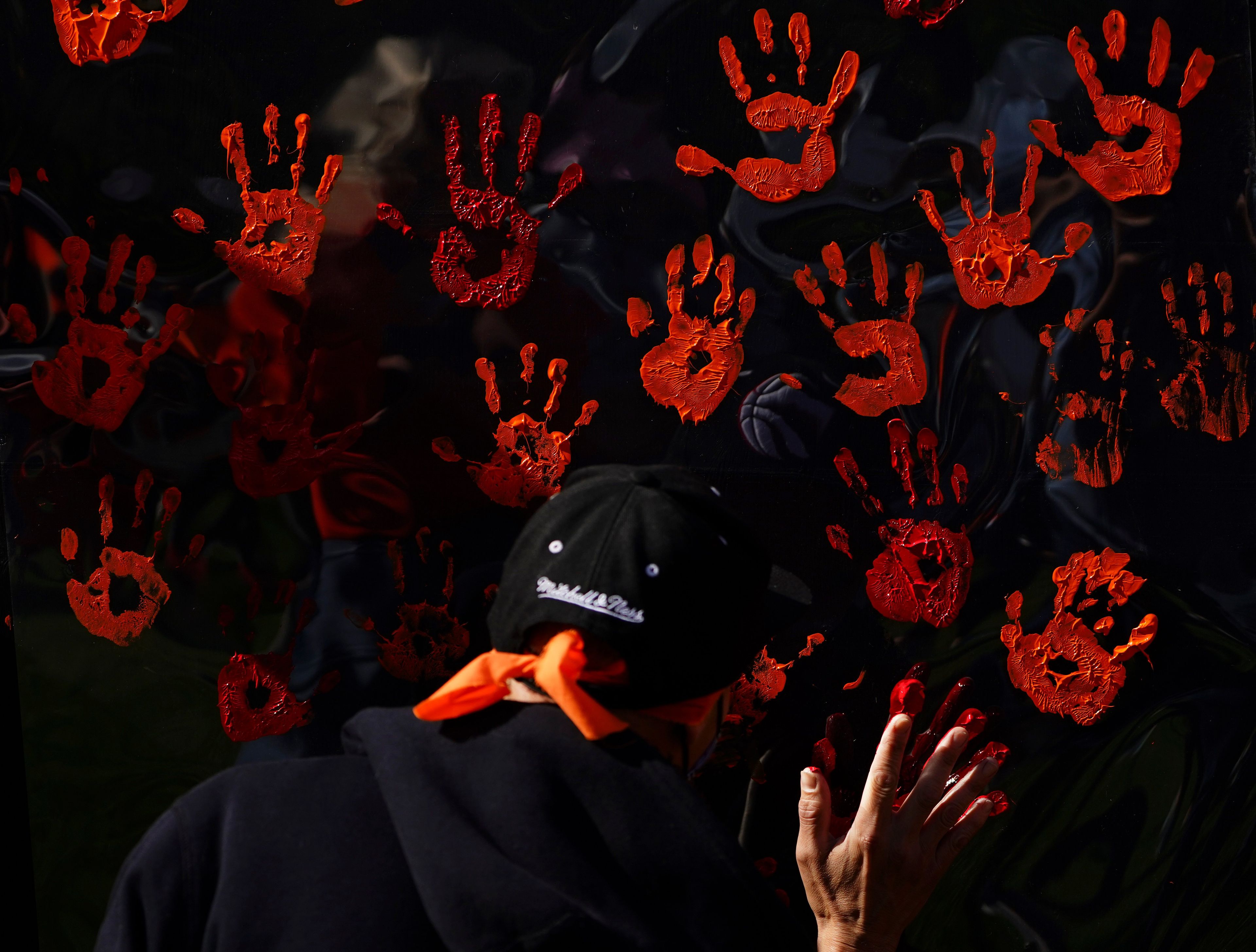 People contribute to a hand painting during the National Day for Truth and Reconciliation in Ottawa on Thursday, Sept. 30, 2021. THE CANADIAN PRESS/Sean Kilpatrick