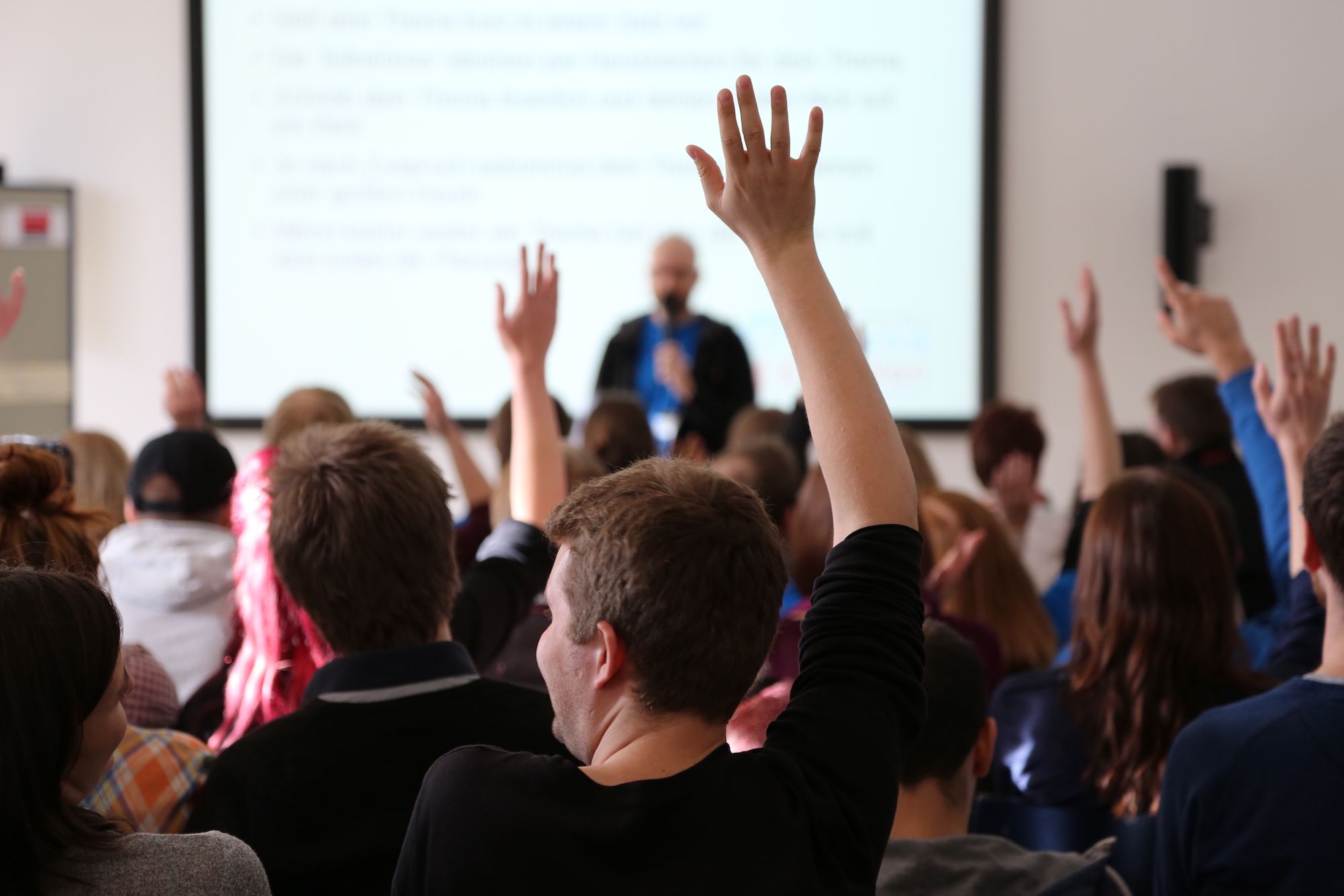 Students Raising Hands During Seminar