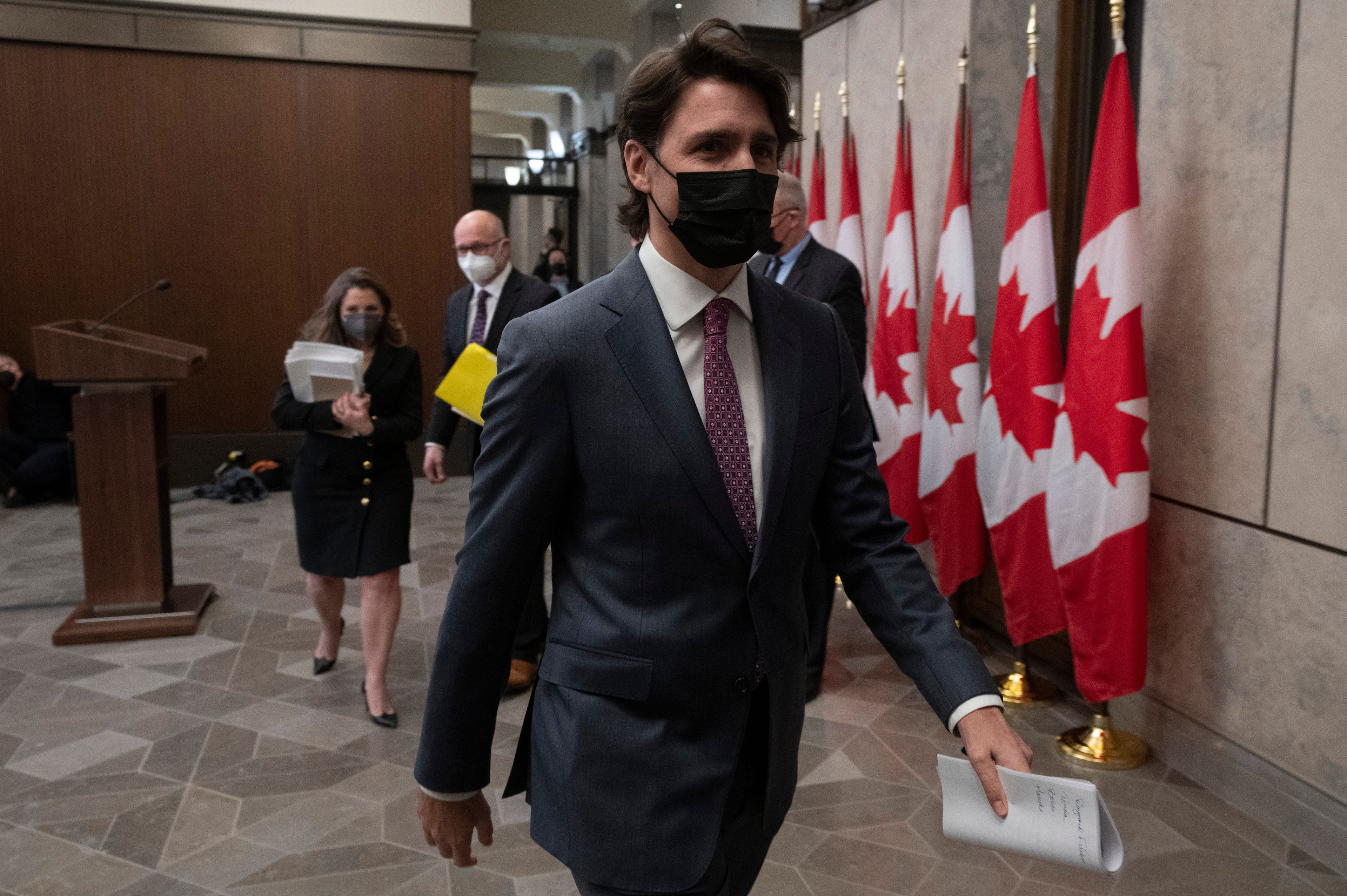 Trudeau leaves a news conference after announcing the Emergencies Act will be invoked, on Feb. 14, 2022 (Adrian Wyld/CP)