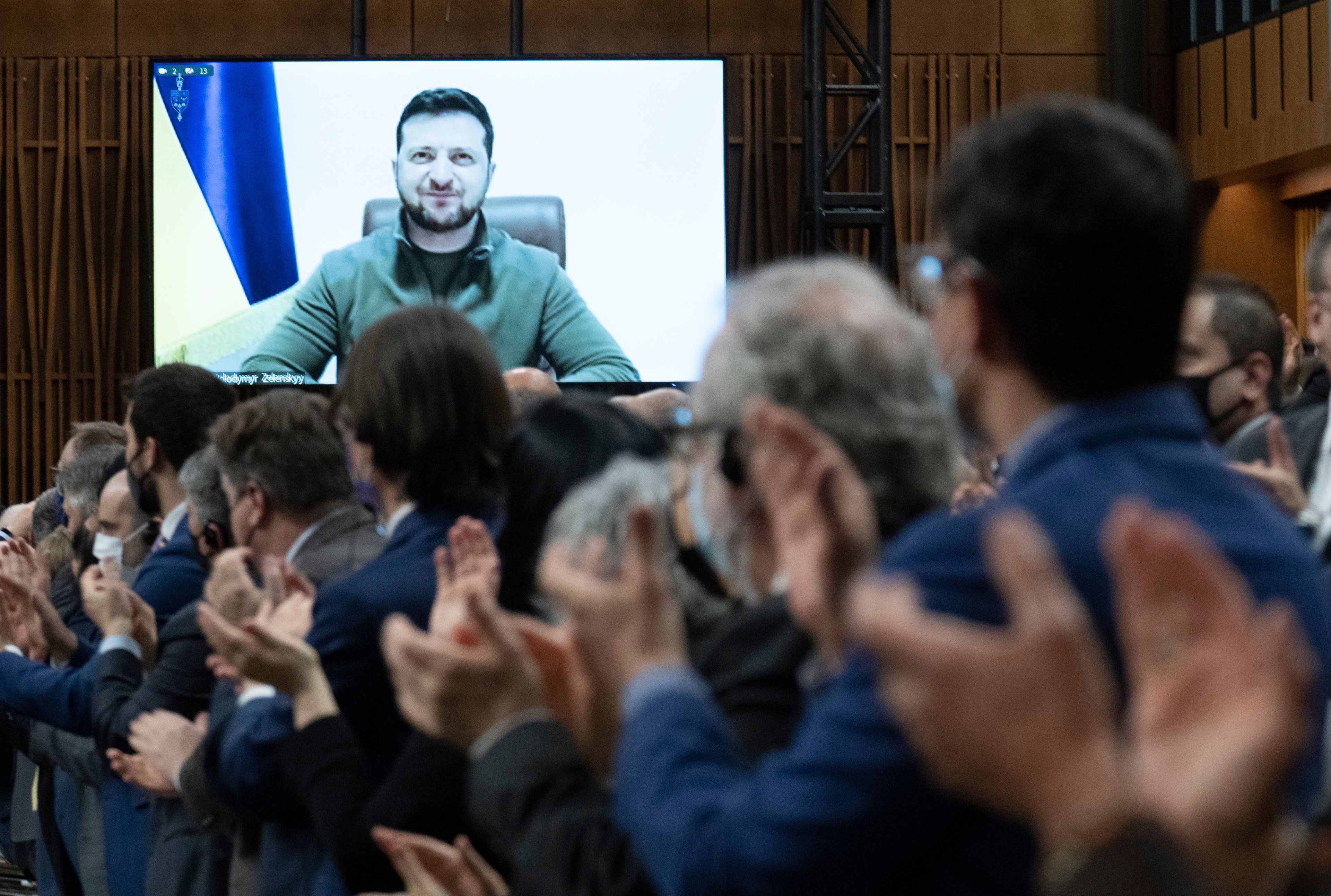 Canadian parliamentarians and guests give Ukrainian President Volodymyr Zelenskyy a standing ovation as he addresses Parliament on March 15, 2022 (Adrian Wyld/CP)