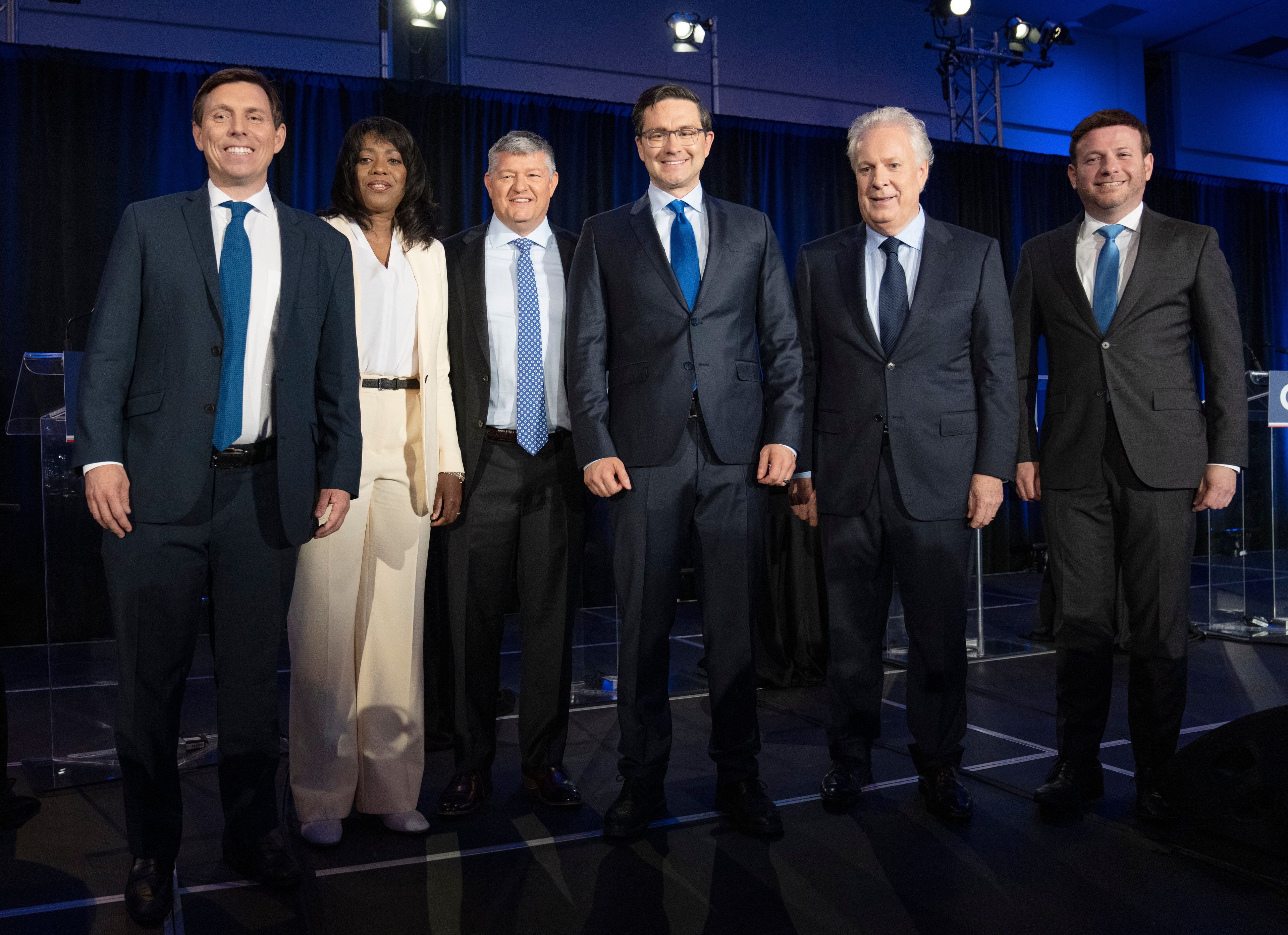 Candidates Patrick Brown, left, Leslyn Lewis, Scott Aitchison, Pierre Poilievre, Jean Charest and Roman Baber, pose for photos after the French-language Conservative Leadership debate Wednesday, May 25, 2022 in Laval, Que.. THE CANADIAN PRESS/Ryan Remiorz