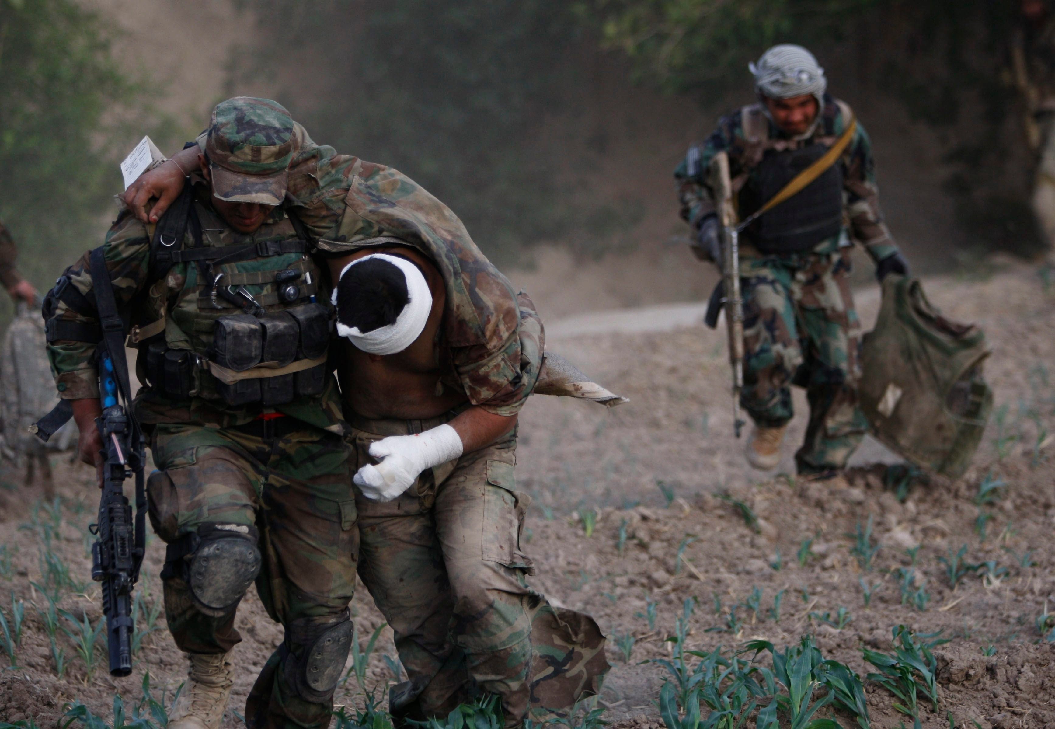 Soldier escorts wounded comrade