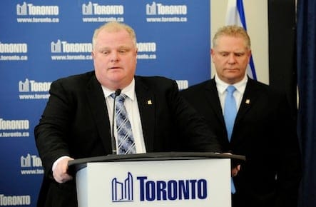Toronto Mayor Rob Ford speaks to the media at City Hall supported by his brother, Councillor Doug Ford after winning his conflict of interest appeal in Toronto