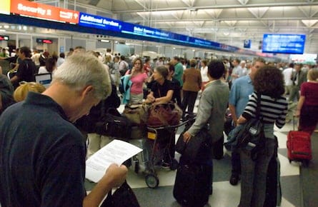 A passenger at Chicago?s O?Hare International reads a flyer with the new regulations on the items that are banned from carry-on luggage