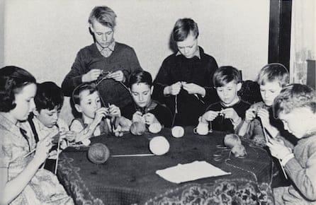 Children help knit socks and other garments for Canadian service personnel. Voluntary organizations like the Canadian Red Cross and the Navy League of Canada distributed them overseas. (George Metcalf Archival Collection / Canadian War Museum)