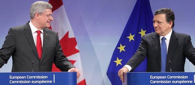 European Commission President Jose Manuel Barroso, right, looks at Canada's Prime Minister Stephen Harper during a media conference at the European Commission headquarters in Brussels, Friday, Oct. 18, 2013. Canada and the European Union finalized a landmark free trade agreement to boost growth and employment in both economies. (AP Photo/Yves Logghe)