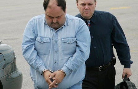 Nelson Lloyd Hart, 36, is escorted to court in Gander, Nfld., on Monday, June 13, 2005.  Hart is charged with two counts of first-degree murder in the deaths of three-year-olds Karen and Krista in August 2002. (CP PHOTO/Scott Cook)