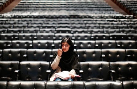 Pakistani teenage activist Yousafzai signs a copy of her book before an event launching her memoir "I Am Malala" in London