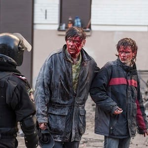 Wounded people are seen after clashes with riot police in central Kiev