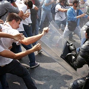 Anti-government protesters clash with police during a protest in Caracas