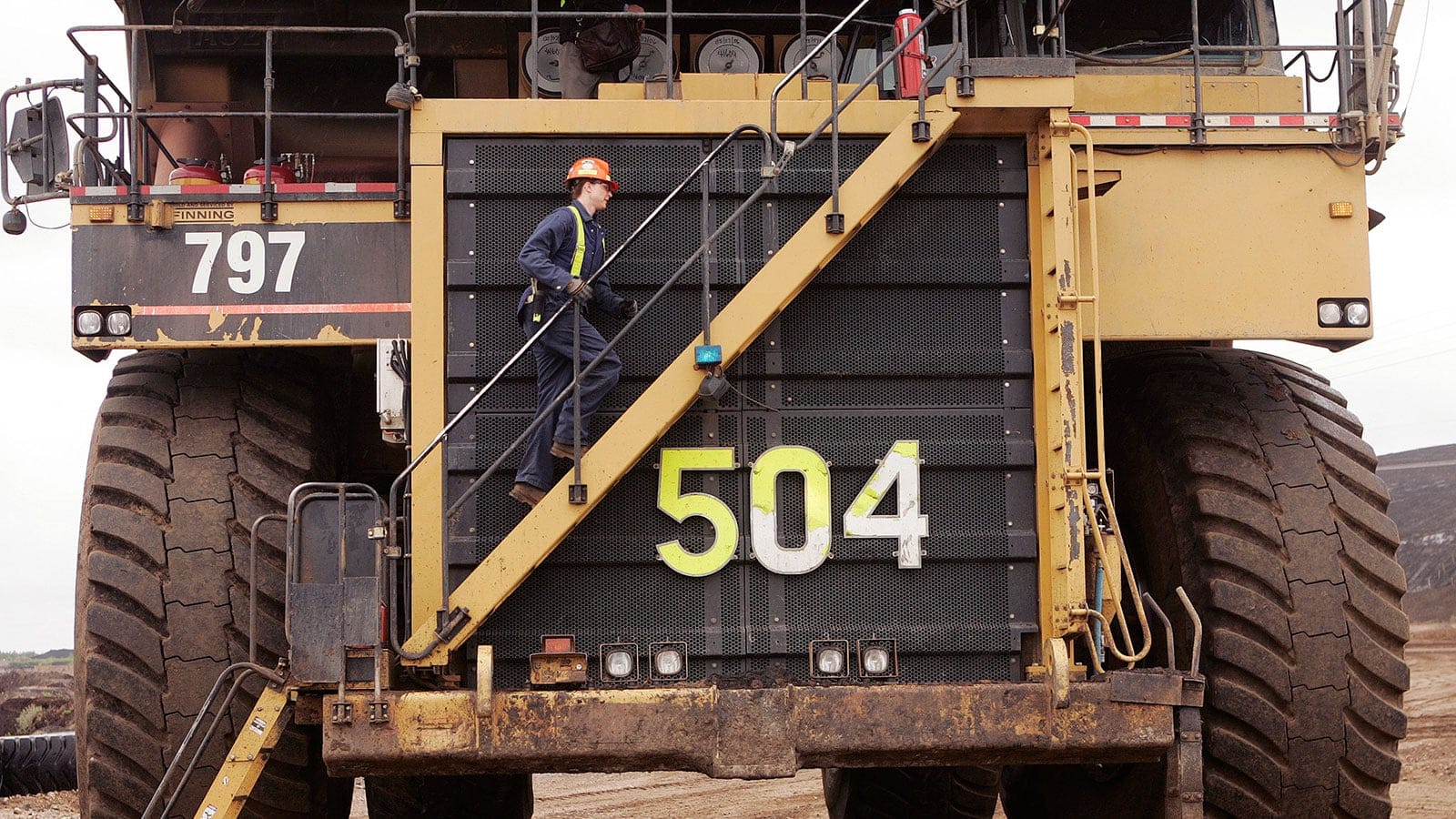 Michelle Noer climbs the steps to the world's largest dump truck at the Syncrude Aurora mine near Fort McMurray, Alta. (Todd Korol/Reuters)