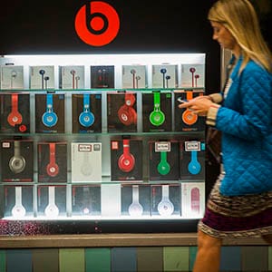 A pedestrian walks past a Beats brand display in the subway system of New York