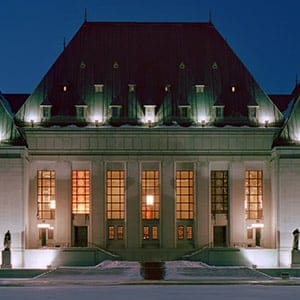 Night photo of front facade of the Supreme Court