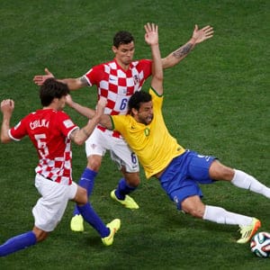 Brazil's Fred is fouled by Croatia's Dejan Lovren inside the area during their 2014 World Cup opening match at the Corinthians arena in Sao Paulo