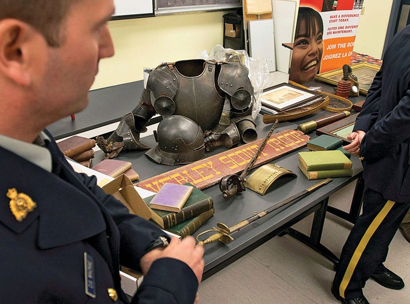 The RCMP display some of the hundreds of historical artifacts discovered at a suburban home, at a news conference in Halifax on Friday, Jan. 25, 2013. John Mark Tillmann has been charged with possessing stolen property. THE CANADIAN PRESS/Andrew Vaughan
