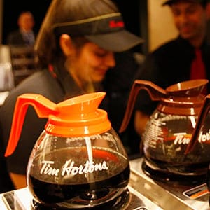 Tim Hortons employees prepare coffee before the company's annual general meeting in Toronto
