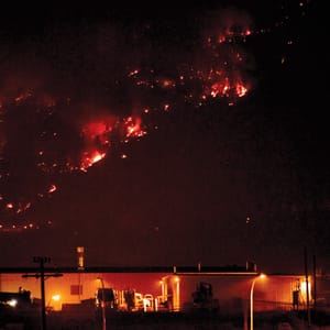 Flames from a forest fire are seen burning on a hillside in West Kelowna, B.C.