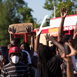 Demonstrators raise their hands while protesting the shooting death of teenager Michael Brown, in Ferguson, Missouri