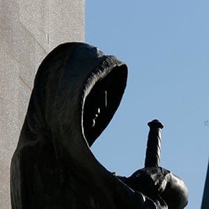 A statue entitled 'Justice' in front the Supreme Court of Canada is framed with the Peace Tower on Parliament Hill in Ottawa