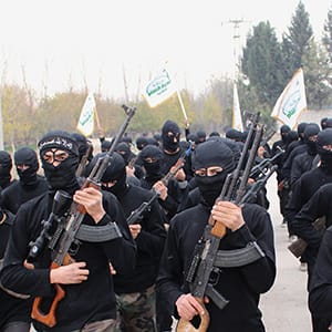 Islamist fighters carry weapons as they march during their graduation ceremony at a camp in eastern al-Ghouta, near Damascus N