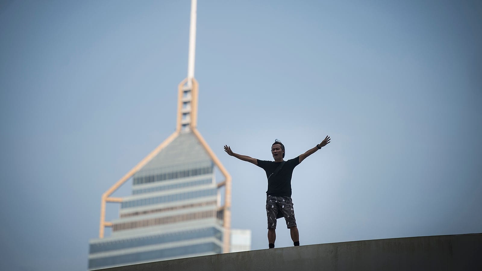 A man threatens to jump of a pedestrian walkway during a pro-democracy protest near the government headquarters buildings in Hong Kong, China on Sunday, Oct. 5, 2014. He demands that the pro-democracy protesters stop occupying the roads to allow his three children aged 7 to 14 to go to school. (Photo by Justin Chin)