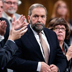 NDP leader Mulcair receives a standing ovation from his caucus while standing to reply to the government's plan to participate in a military campaign against Islamic State militants
