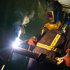 A welder works fabricating an piece of equipment at Sequoia Environmental Remediation a leading environmental supply and service company in Calgary.