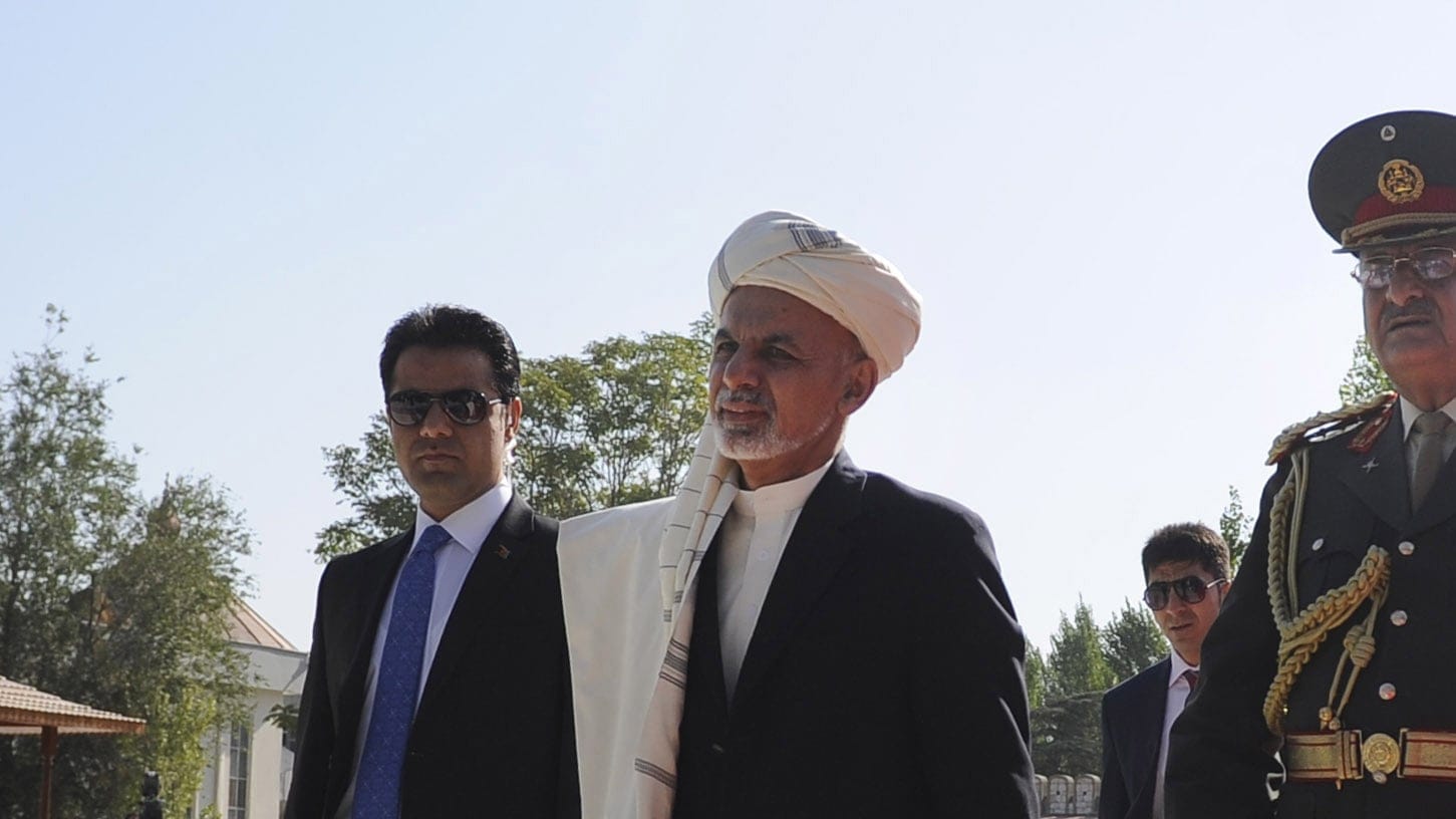 Afghan President Ashraf Ghani, centre, arrives to attend a press conference after offering Eid al-Adha prayer in Kabul, Afghanistan. (Jawad Jalali/EPA)