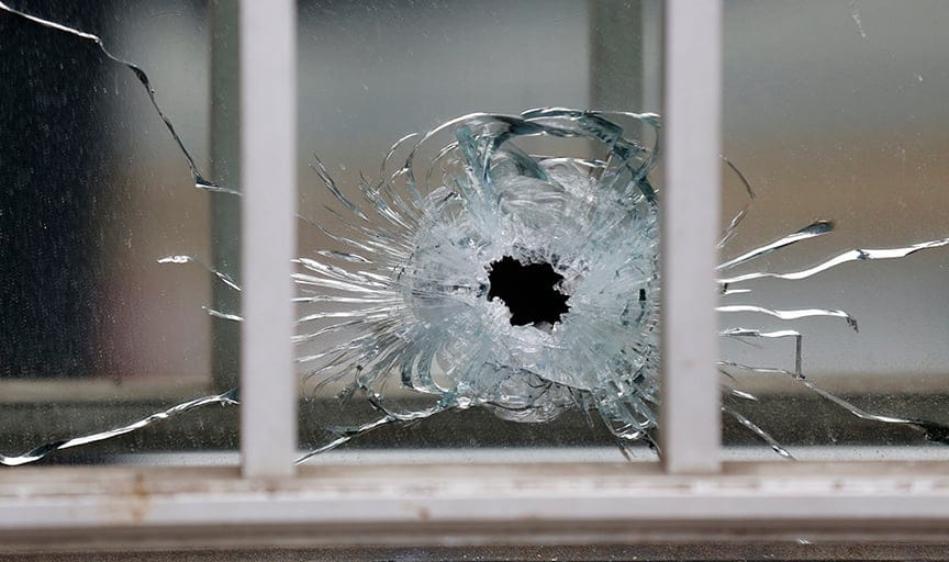 A bullet's impact is seen on a window at the scene after a shooting at the Paris offices of Charlie Hebdo, a satirical newspaper,