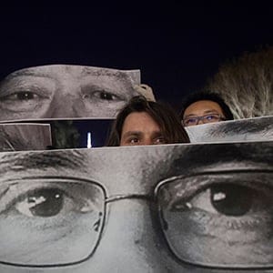 People participate in a vigil to pay tribute to the victims of a shooting, by gunmen at the offices of weekly satirical magazine Charlie Hebdo in Paris, in the Manhattan borough of New York