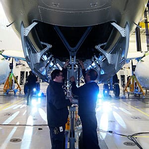 Bombardier workers look at the CS300 aircraft after it was unveiled at a news conference at its assembly facility in Mirabel, Quebec