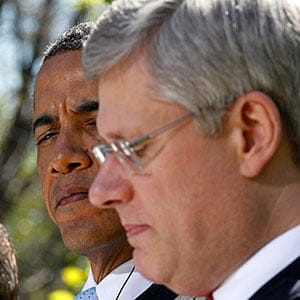U.S. President Obama listens to Canada's Prime Minister Harper during joint news conference with Mexico's President Felipe Caldero Mexico's President Calderon in the White House Rose Garden in Washington