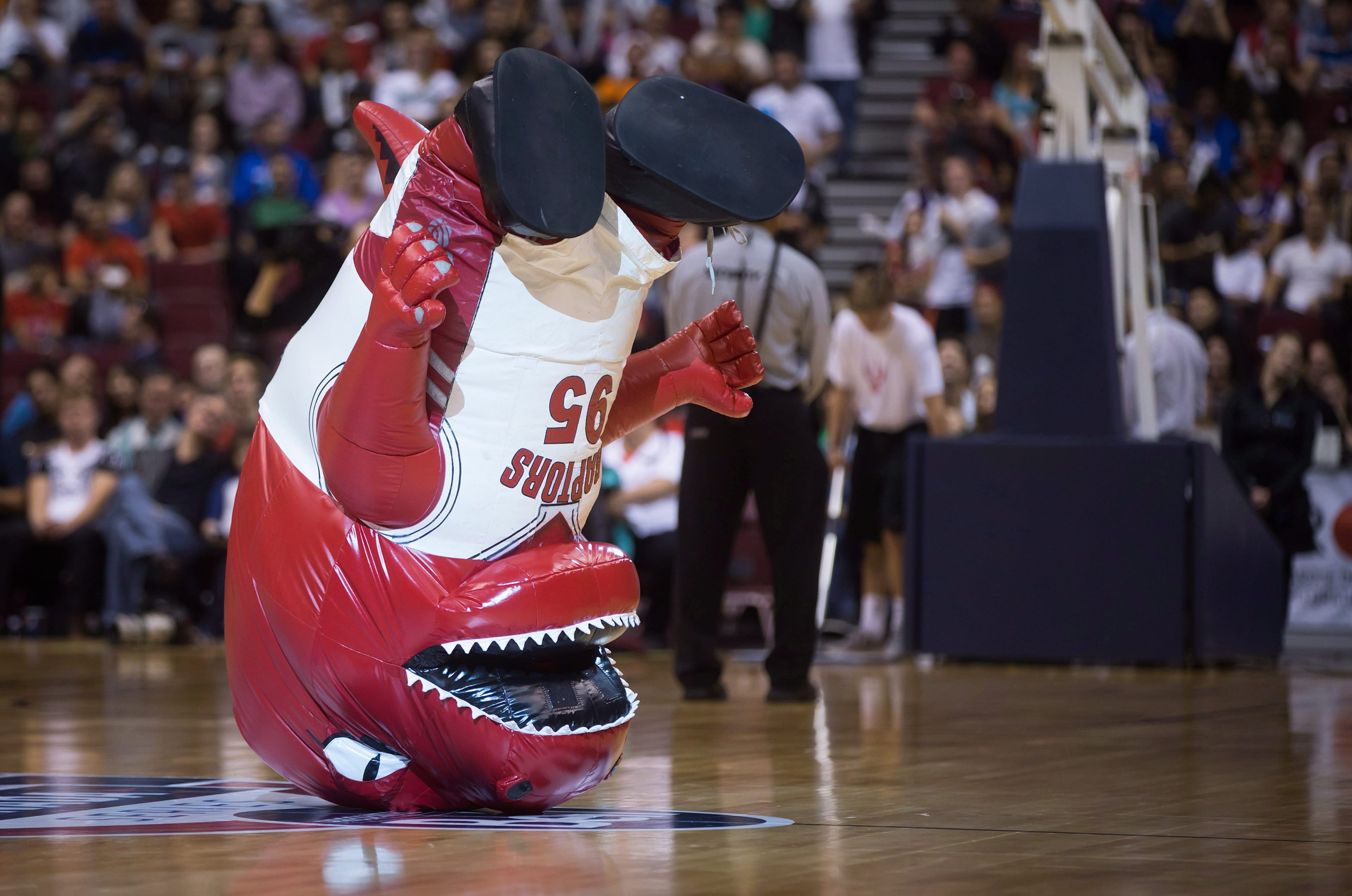 Toronto Raptors' mascot "The Raptor" performs during a break in play as the team plays the Sacramento Kings during the first half of a pre-season NBA basketball game in Vancouver, on Sunday October 5, 2014. (Darryl Dyck/CP)
