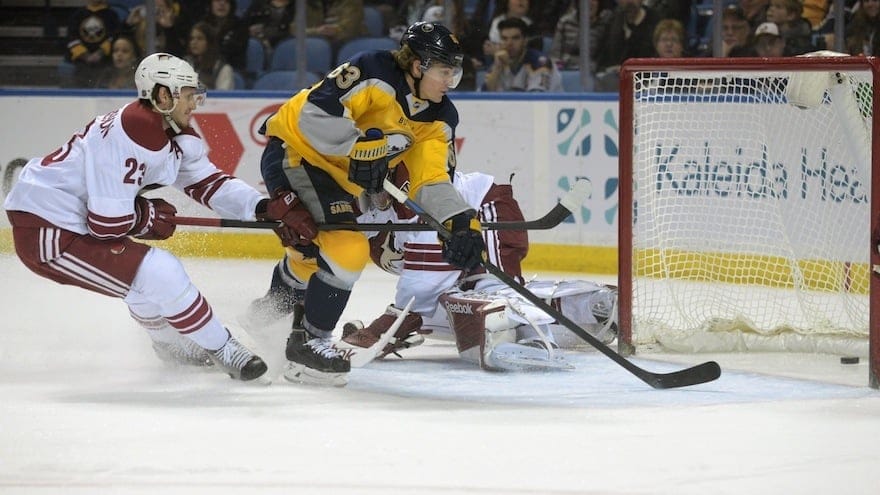 Buffalo Sabres center Tyler Ennis (63) scores against Arizona Coyotes defenseman Oliver Ekman-Larsson (23), of Sweden, during the first period of an NHL hockey game Thursday, March 26, 2015, in Buffalo, N.Y.  Arizona won in overtime 4-3. (AP Photo/Gary Wiepert)
