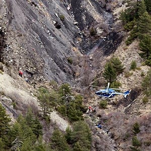 A French gendarme helicopter flies over the crash site of an Airbus A320, near Seyne-les-Alpes