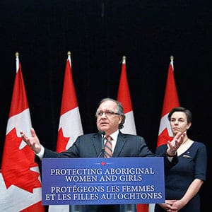 Canada's Aboriginal Affairs Minister Valcourt speaks during a news conference with Labour and Status of Women Minister Leitch in Ottawa