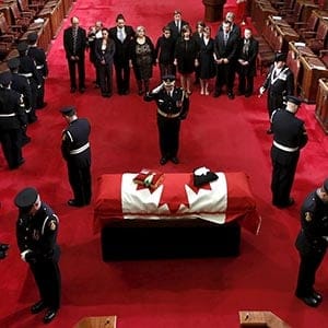 The casket of the late Senate Speaker Nolin is saluted as he lies in repose in the Senate Chamber in Ottawa