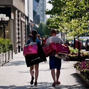 Shoppers carry bags from Holt Renfrew luxury department store while walking on Bloor Street West in Toronto, Ontario, Canada, on Saturday, June 15, 2013. Statistics Canada (STCA) is scheduled to release retail sales figures on June 21. (Galit Rodan/Bloomberg/Getty Images)