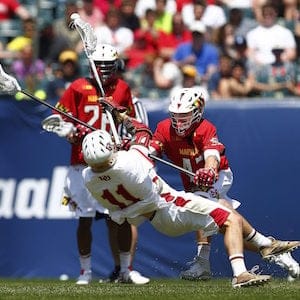CORRECTS DAY TO MONDAY -  Maryland's Mac Pons (43) checks Denver's Jack Bobzien (11) during the first half of the NCAA Division I men's lacrosse championship, Monday, May 25, 2015, Philadelphia. (AP Photo/Rich Schultz)