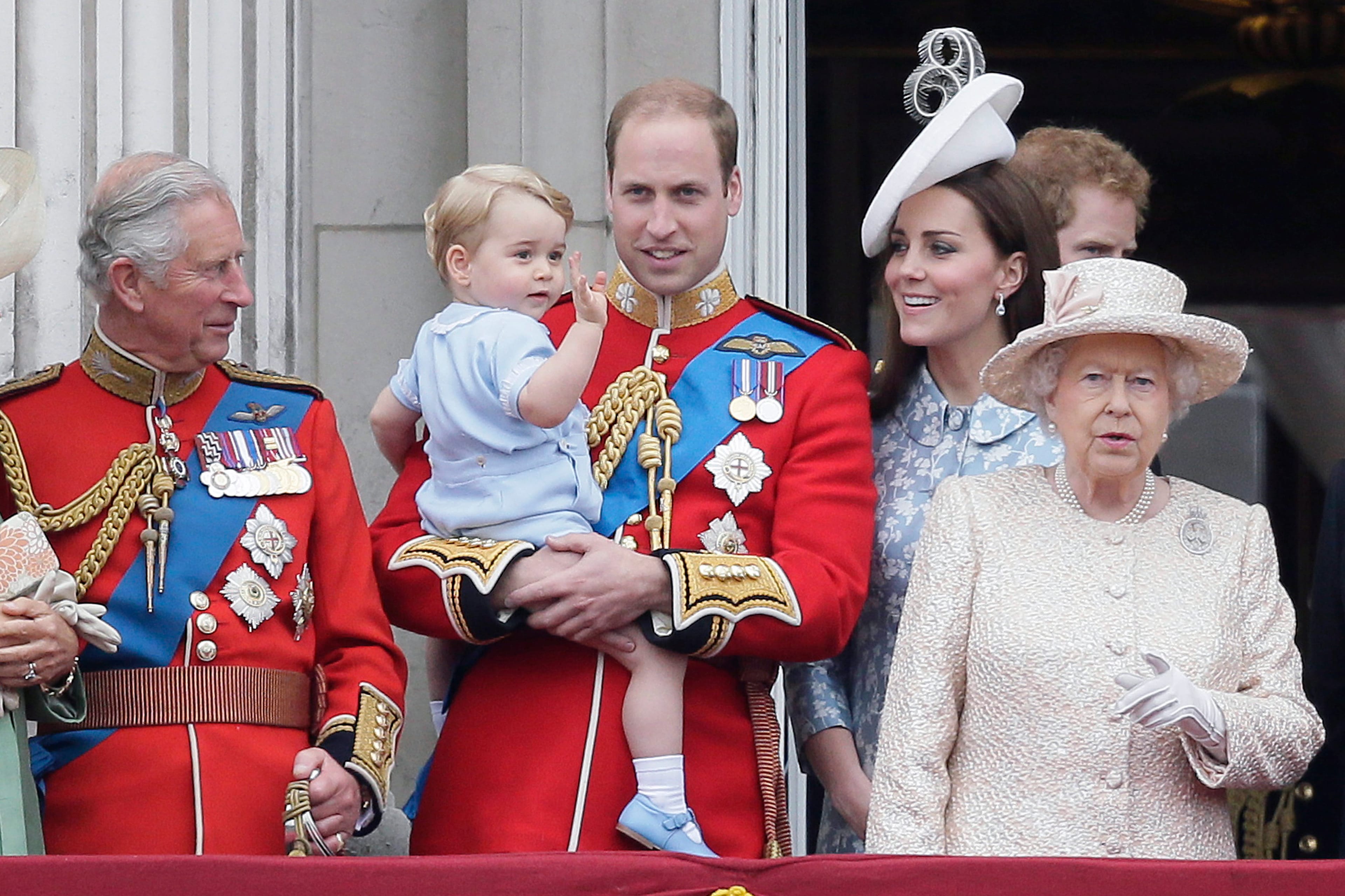 Britain's Prince William holds his son Prince George, with Queen Elizabeth II, right, Kate, Duchess of Cambridge and the Prince of Wales during the Trooping The Colour parade at Buckingham Palace, in London, Saturday, June 13, 2015. Hundreds of soldiers in ceremonial dress have marched in London in the annual Trooping the Color parade to mark the official birthday of Queen Elizabeth II. The Trooping the Color tradition originates from preparations for battle, when flags were carried or "trooped" down the rank for soldiers to see. (AP Photo/Tim Ireland)
