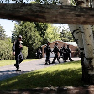 Corrections officers walk through a residential area during a search for two escaped prisoners from Clinton Correctional Facility, on Wednesday, June 24, 2015, in Malone, N.Y. Hundreds of searchers checked ATV trails and logging roads and went door-to-door in far northern New York trying to close in on David Sweat and Richard Matt, who escaped from the maximum-security prison more than two weeks ago. (AP Photo/Mike Groll)