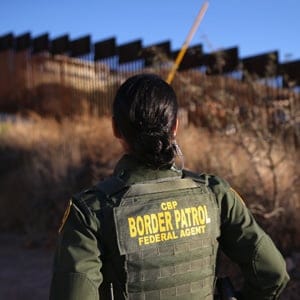 NOGALES, AZ - DECEMBER 09:  U.S. Border Patrol agent Nicole Ballistrea watches over the U.S.-Mexico border fence on December 9, 2014 in Nogales, Arizona. With increased manpower and funding in recent years, the Border Patol has seen the number illegal crossings and apprehensions of undocumented immigrants decrease in the Tucson sector. Agents are waiting to see if the improved U.S. economy and housing construction will again draw more immigrants from the south.  John Moore/Getty Images