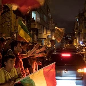 Supporters wave Kurdish flags as they celebrate election results in Turkey. (Photograph by Adnan Khan)