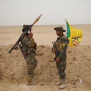 fighters of Kataeb Hizbullah of Popular Mobilization stand on guard in the Desert  near Ankur village east of Anbar province on May 28, 2015 in Anbar, Iraq 
 (Ahmad Mousa/The Washington Post/Getty Images)