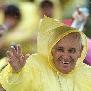 Pope Francis, wearing a plastic poncho, waves to well-wishers after a mass in Tacloban on January 17, 2015. Pope Francis braved heavy rain on January 17 to celebrate an emotional mass with a sea of weeping survivors of a super typhoon in the Philippines that killed thousands, saying their pain silenced his heart.     JOHANNES EISELE/AFP/Getty Images