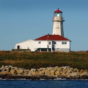 The Canadian flag  flutters in the breeze Monday, Sept. 8, 2003, by the lighthouse at Machias Seal Island.  The Canadians man the lighthouse on this island  claimed by the US and Canada in The Gray Zone waters between the two countries. (AP Photo/Fred J. Field )