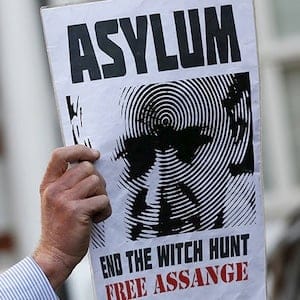 A supporter of Wikileaks founder Julian Assange holds a placard during a gathering outside the Ecuador embassy in London, Britain June 19, 2015. Stefan Wermuth/Reuters