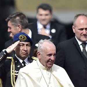Pope Francis (C) is welcomed by Ecuador's President Rafael Correa (R) as he arrives at the Mariscal Sucre international airport in Quito on July 5, 2015. Pope Francis arrived in Quito Sunday to begin his first South American trip in two years, for an eight-day tour of Ecuador, Bolivia and Paraguay highlighting the plight of the poor on his home continent. AFP PHOTO / RODRIGO BUENDIA        (Photo credit should read RODRIGO BUENDIA/AFP/Getty Images)